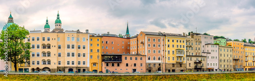Historic colorful houses along the bank of the Salzach River  Salzburg  Austria.