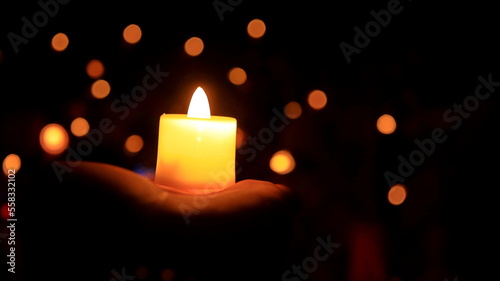 Candles glowing against dark background closeup