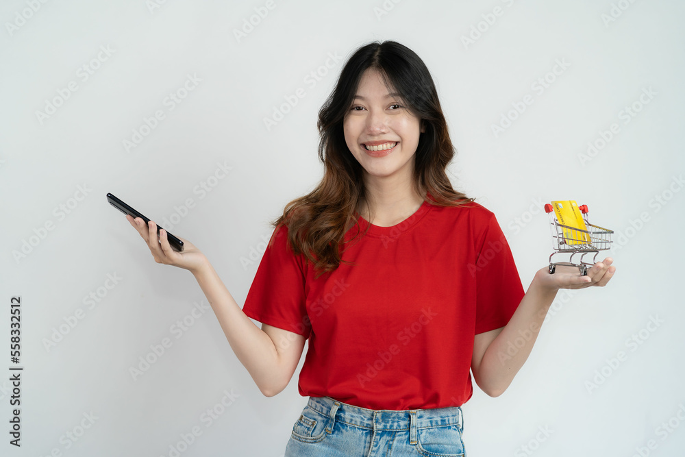 Asian woman holding smartphone and credit card on white background, name concept of online and paying Asian woman holding smartphone and credit card on white background, name concept of online and paying