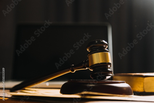 Business and lawyers discussing contract papers with brass scale on desk in office. Law, legal services, advice, justice and law concept picture with film grain effect