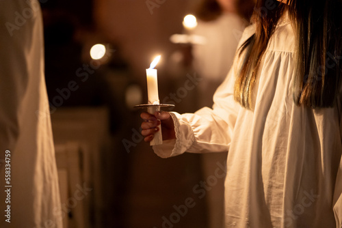 People handling candles in the hands. Christmas and lucia holidays photo