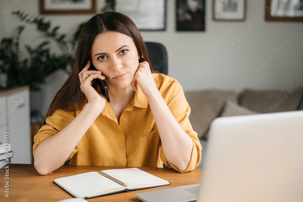 Bored tired woman using laptop for remote work, sitting in living room, student or freelancer feeling tired or disinterested in current activities