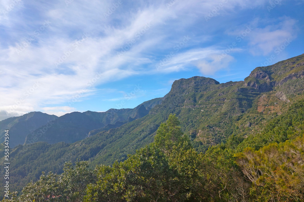 Beautiful green mountains against the backdrop of the blue sky on the island of Madeira.