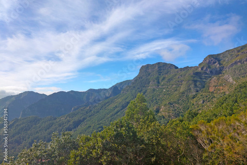 Beautiful green mountains against the backdrop of the blue sky on the island of Madeira.
