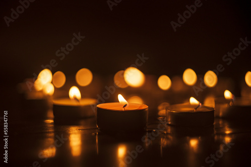 candles are burning in the dark on the floor