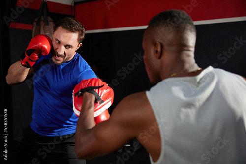 sportsman or fighter training boxing in the gym © offsuperphoto