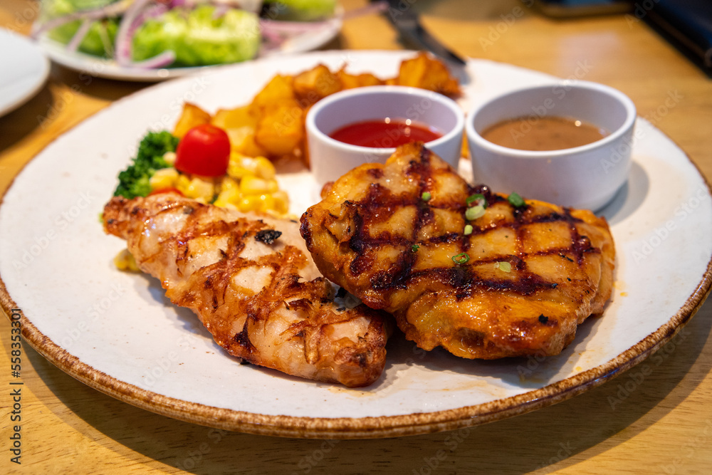 Grilled chicken and pork steak with sauces sided with Grilled chicken and pork steak with sauces sided with