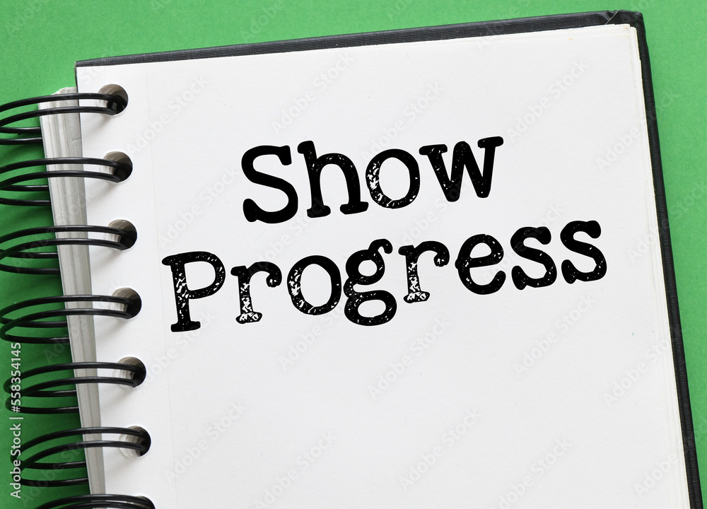 SHOW PROGRESS words in an office notebook. SHOW PROGRESS words in an office notebook.