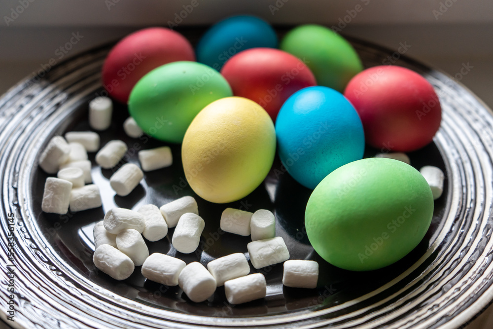 Easter eggs and marshmallow on the dark plate. Close up Easter eggs and marshmallow on the dark plate. Close up