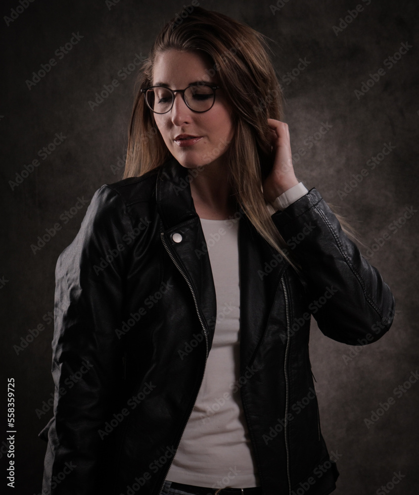 Close-up of a young attractive woman against dark grey background - studio photography Close-up of a young attractive woman against dark grey background - studio photography