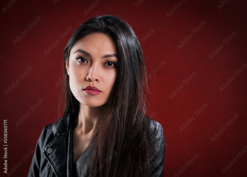 Young self-confident woman against a red background - studio photography Young self-confident woman against a red background - studio photography