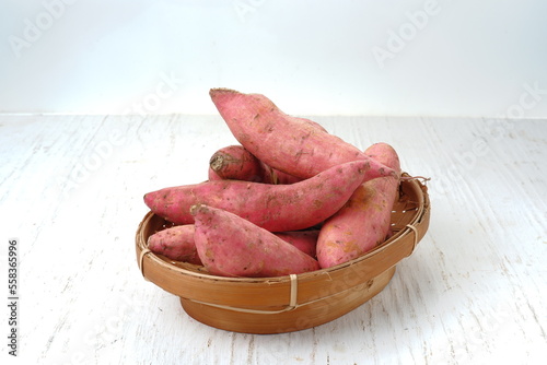 Sweet potato in bamboo basket on white background