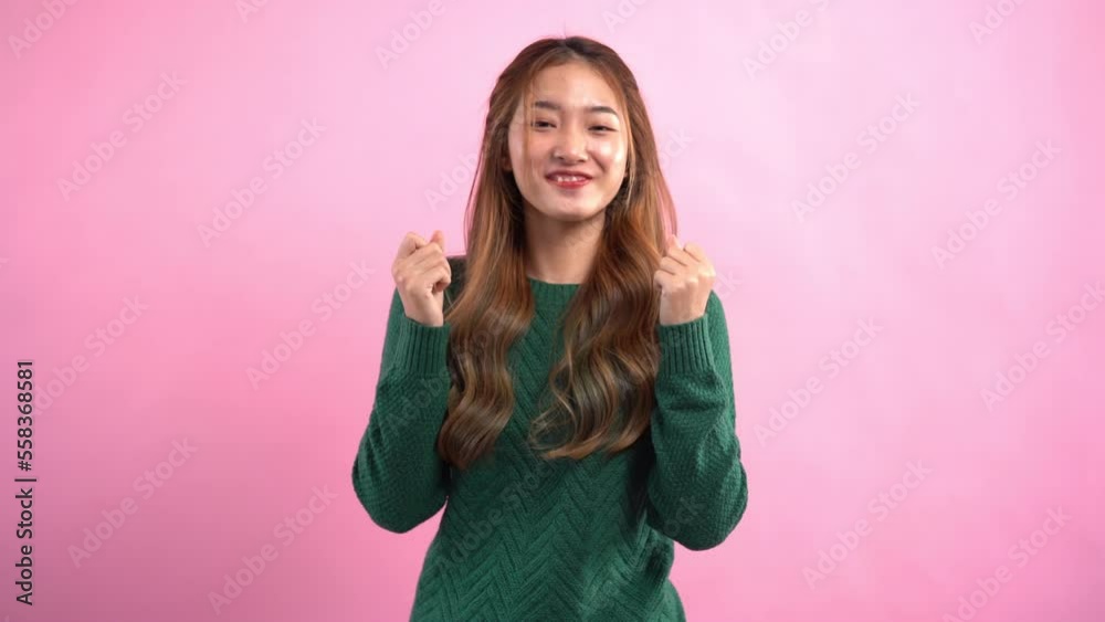 Young women thumb up with both hands and smiling with empty space on isolated pink background Young women thumb up with both hands and smiling with empty space on isolated pink background