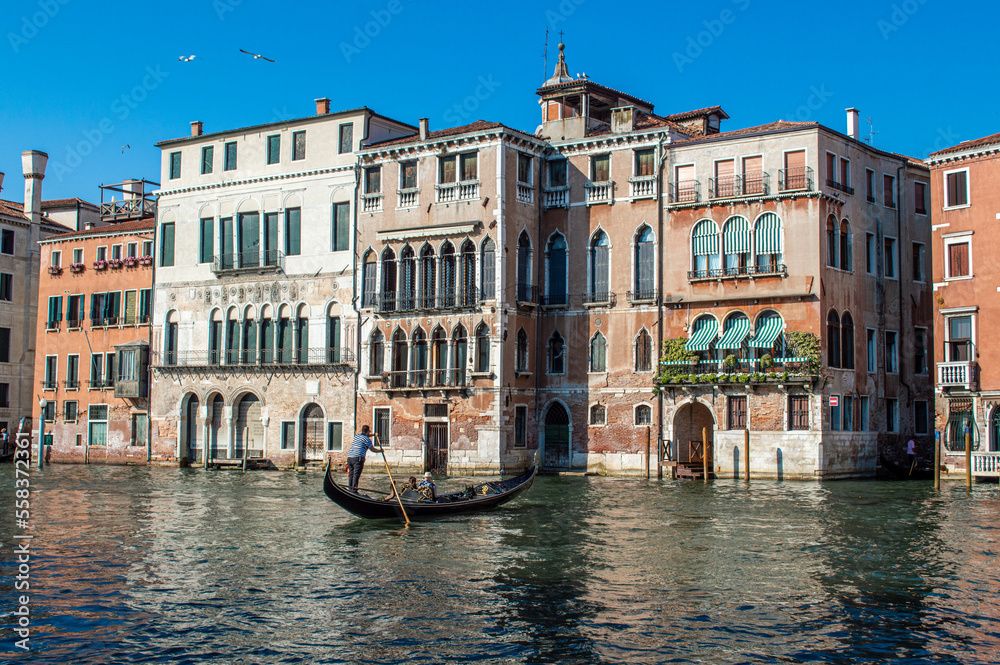 View of the Venetian Canal on a sunny day, buildings and boats. Venice, Italy	
