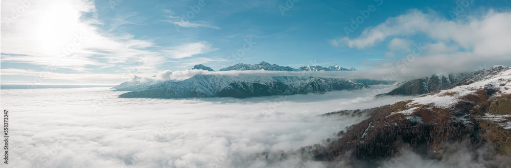 Alps panoramic view with clouds during winter aerial shot