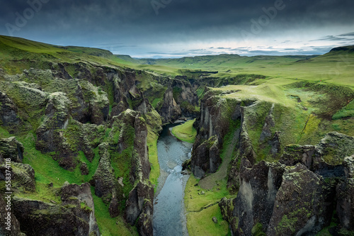 Stunning view of Fjadrargljufur canyon naturally eroded with Fjadra flowing through ravine in summer at Iceland