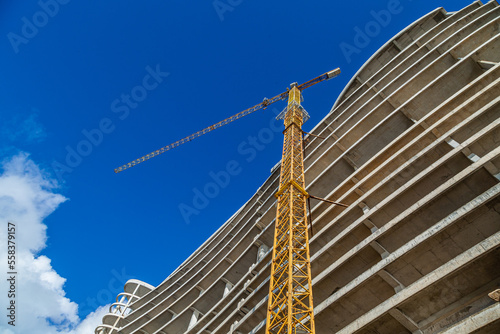 Construction crane and unfinished building, bottom view