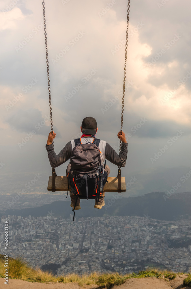 man on a swing on the rucu mountain in quito ecuador