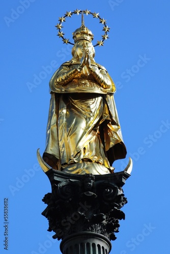 Gilded statue of St. Mary, with a crown and standing on a crescent moon, on a column (Graz, Styria, Austria).