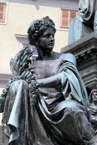 Bronze statue in Hauptplatz, Graz, Austria depicting of a young woman with several grain heads in her hand.