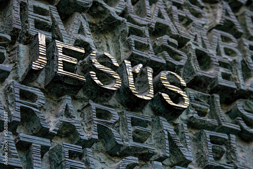 Aged 3D golden letters depiction the name of Jesus.