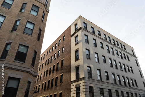 Very generic urban brick apartment buildings with rowns of windows, urban cityscape, horizontal aspect