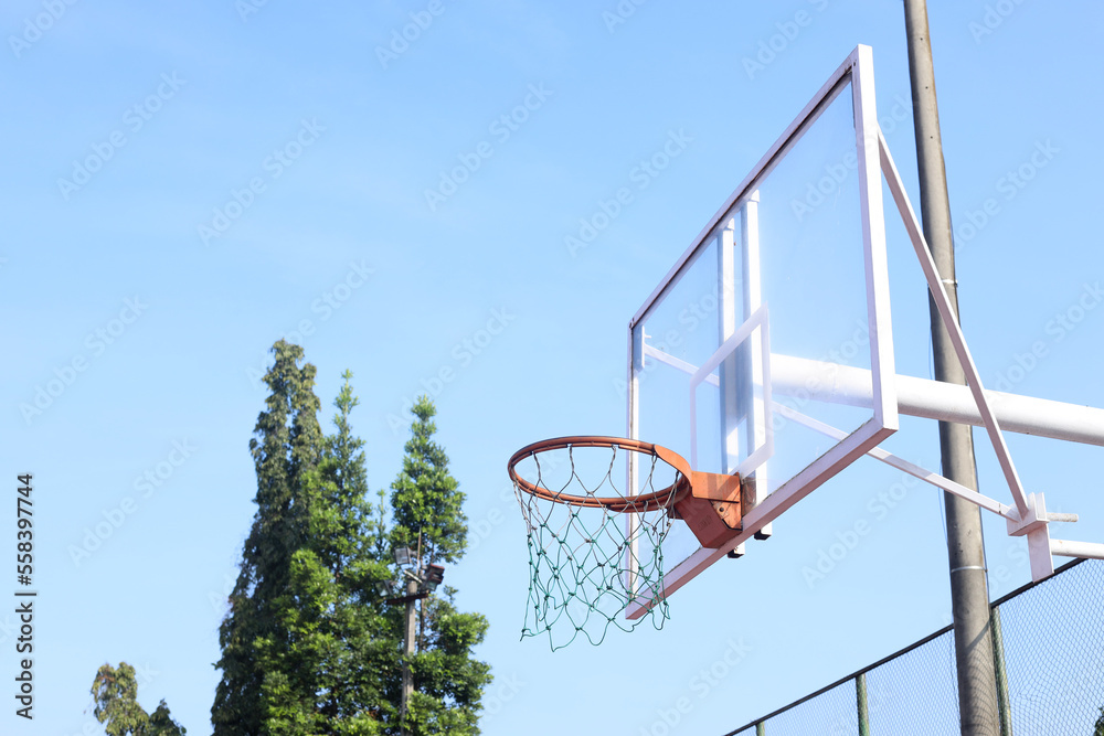 Basketball hoop and net at blue sky background on a summer day.