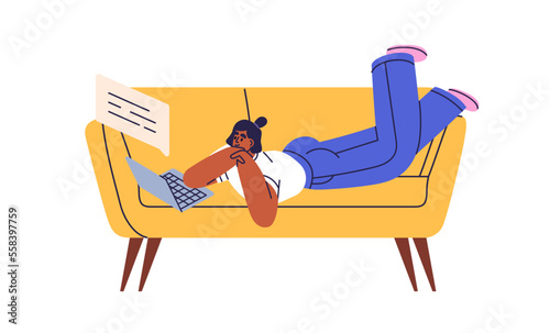Person with laptop computer on sofa. Black woman lying on couch, chatting onl...