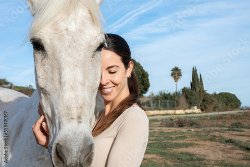 Canvas Print Young happy woman embracing his horse