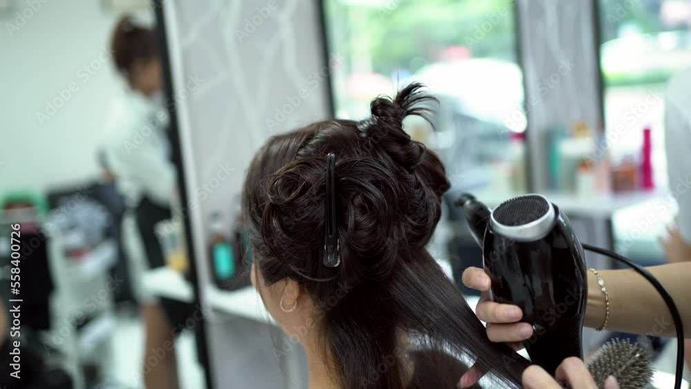 Beautician doing hair for customers she is a beautiful woman
Beautician doing hair for customers she is a beautiful woman