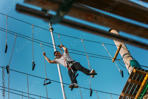 Man stepping on ropes in the adventure park