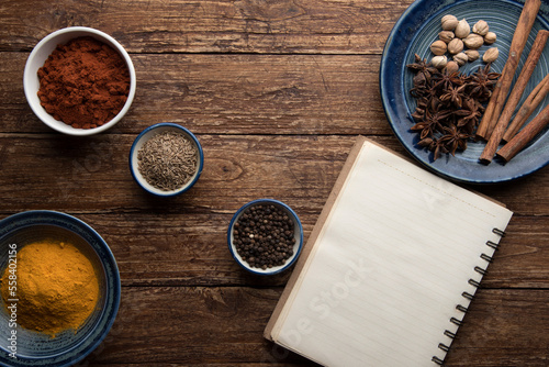 pices and herbs on old kitchen table. Food and cuisine ingredients. photo