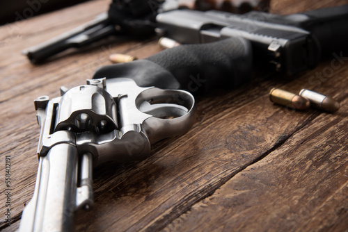 Gun, Pistol with ammunition on wooden background.