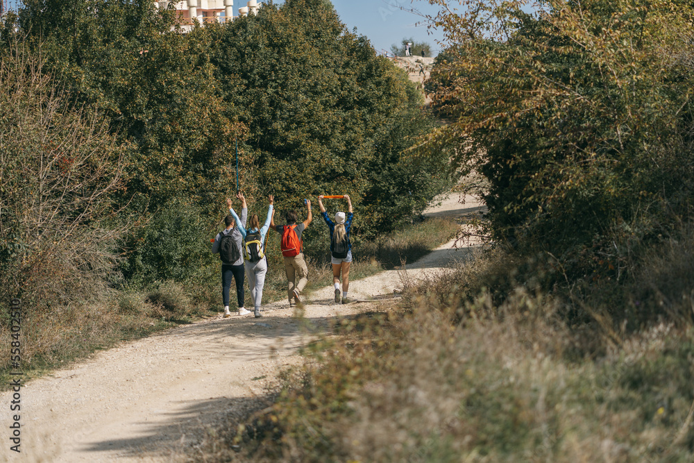 Happy sporty hikers walking and having fun Happy sporty hikers walking and having fun