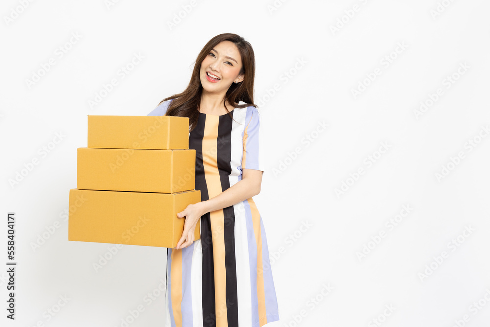 Happy Asian woman holding package parcel box isolated on white background, Delivery courier and shipping service concept Happy Asian woman holding package parcel box isolated on white background, Delivery courier and shipping service concept