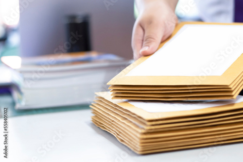 Canvas Print Soft focus of office clerk or secretary is preparing documents and brown envelopes for those interested in bidding for the construction of a large building in an office