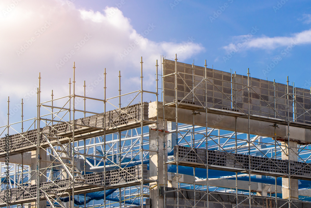 Scaffolding pipe clamp and parts,construction site with scaffold and building strength to scaffold clamps in used on construction site with sunset background,scaffolding for construction factory