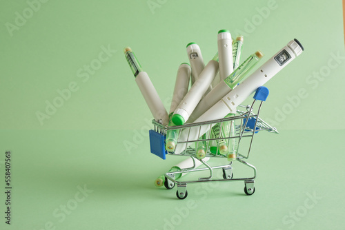 a lot of insulin pen syringes in a mini shopping cart