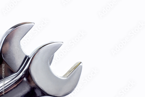 Silver metal wrench for maintenance close up on white background with copy space. photo