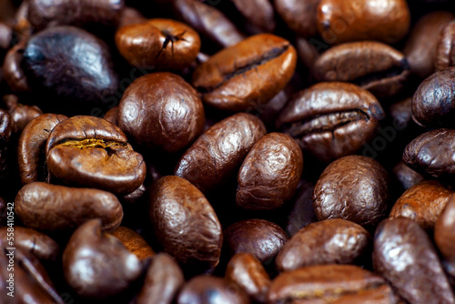 Dark brown roasted coffee beans as a texture close up.