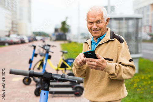 Grandfather wants to ride an electric scooter and pays rent with mobile phone
