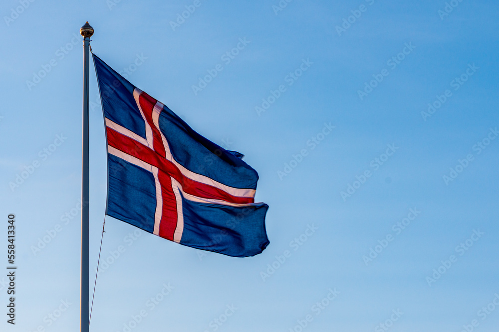 Icelandic flag moving in the wind isolated in front of blue sky
