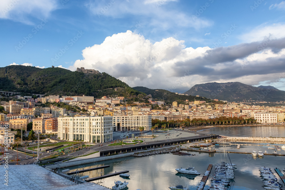 Naklejka premium Touristic City by the Sea. Salerno, Italy. Aerial View. Cityscape and mountains background