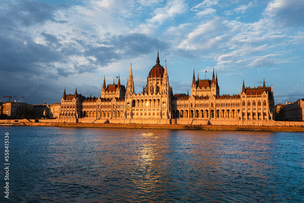 Fototapeta premium Hungarian Parliament Building along river Danube at dawn with colorful clouds sky