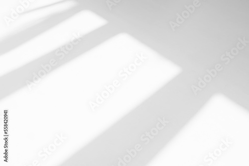 Abstract shadow and striped diagonal light background in office room  on white wall  from window.  Shadows dark gray and sunshine diagonal geometric effect overlay for backdrop and mockup design