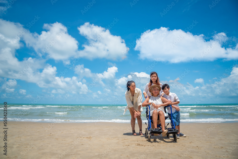 Happy Asian diversity generation family standing on tropical beach in summer at daytime Happy Asian diversity generation family standing on tropical beach in summer at daytime