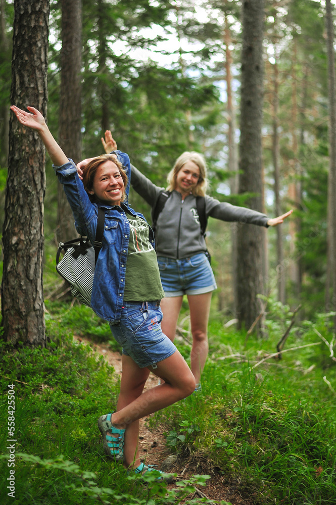 Fototapeta premium charming cute smiling girls with an open, honest faces against a forest in a soft light