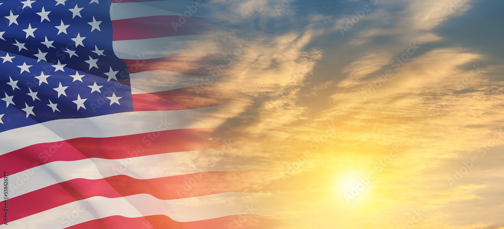 Fototapeta premium United States of America flag on sky at sunset or sunrise background. Independence day, Memorial day, Veterans day. Banner.