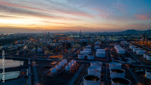 Oil and gas refinery plant or petrochemical industry on blue sky sunset background, Factory at twilight time, Gas furnace and smoke stack in petrochemical industrial