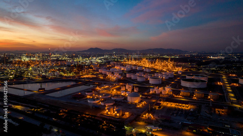 Oil and gas refinery plant or petrochemical industry on blue sky sunset background, Factory at twilight time, Gas furnace and smoke stack in petrochemical industrial